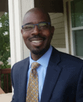 Smiling man with glasses wearing a suit