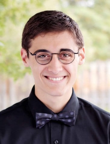 Mead High School Graduate in a black button up shirt and bow tie. 