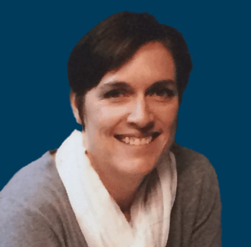Erica Bowman smiling in front of a navy blue background.