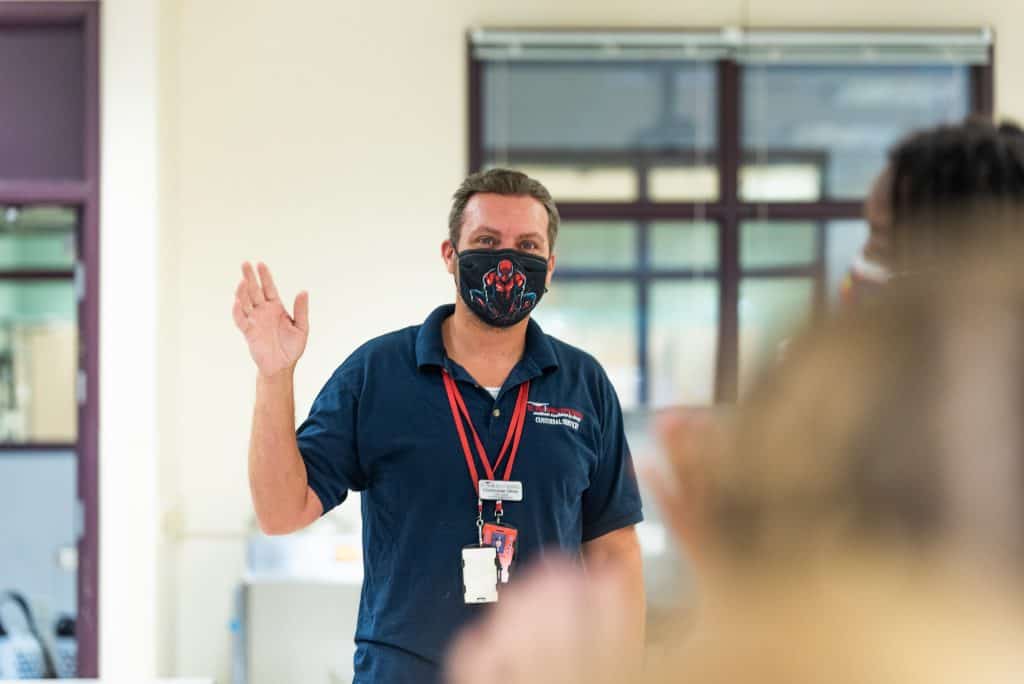 Chris Ulmer waving to students