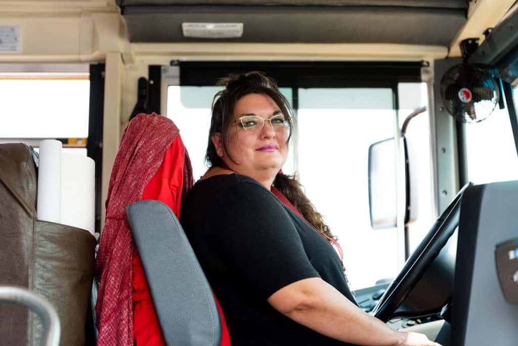 Bus driver Annette sitting in a school bus