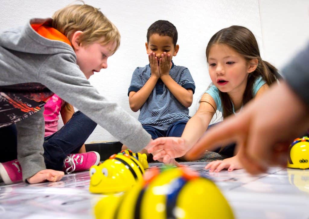 Preschool aged students playing during robotics lesson