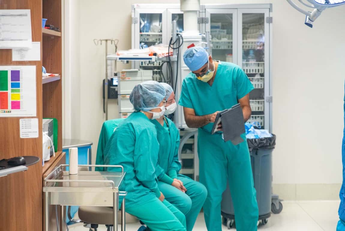 Students and a doctor in scrubs