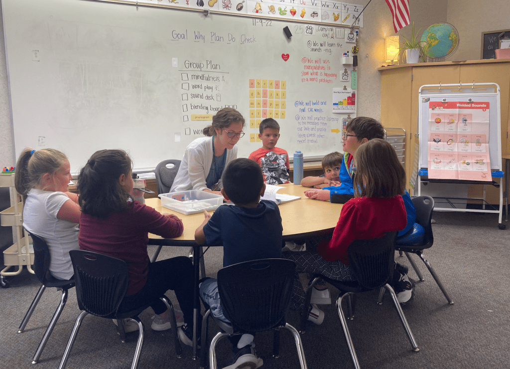 Teacher working with students in a group