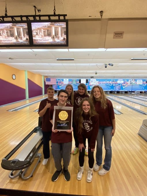 Unified Bowling students from Silver Creek HS pose for a picture with their trophy
