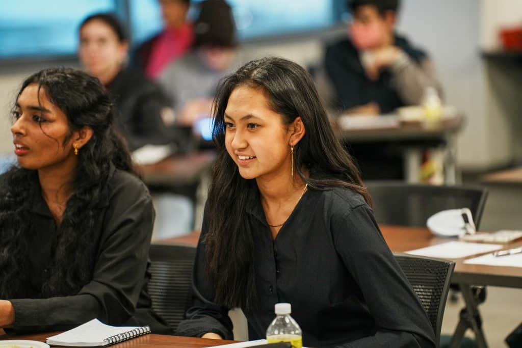 Sarada Gundavarapu and Micky Nguyen, founders of the Future Medical Professionals Club, sitting at a table during the UCHealth Panel.