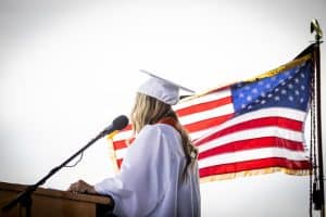 Student at Graduation with Flag