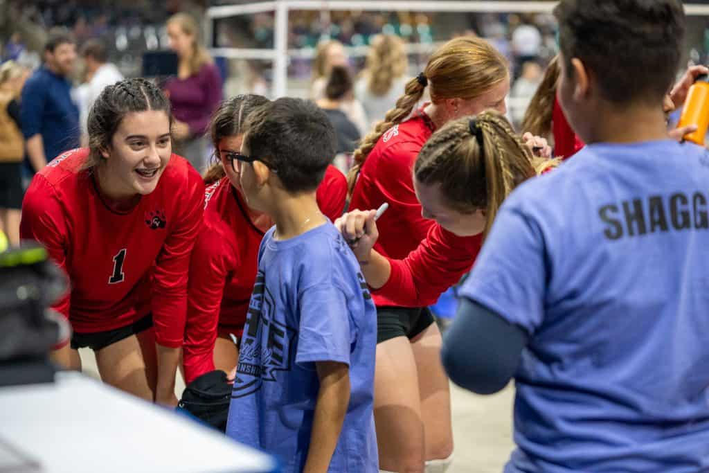 Students from St. Vrain meet volleyball players after their match and get their autographs on their shirt.