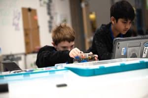 two students coding robotics