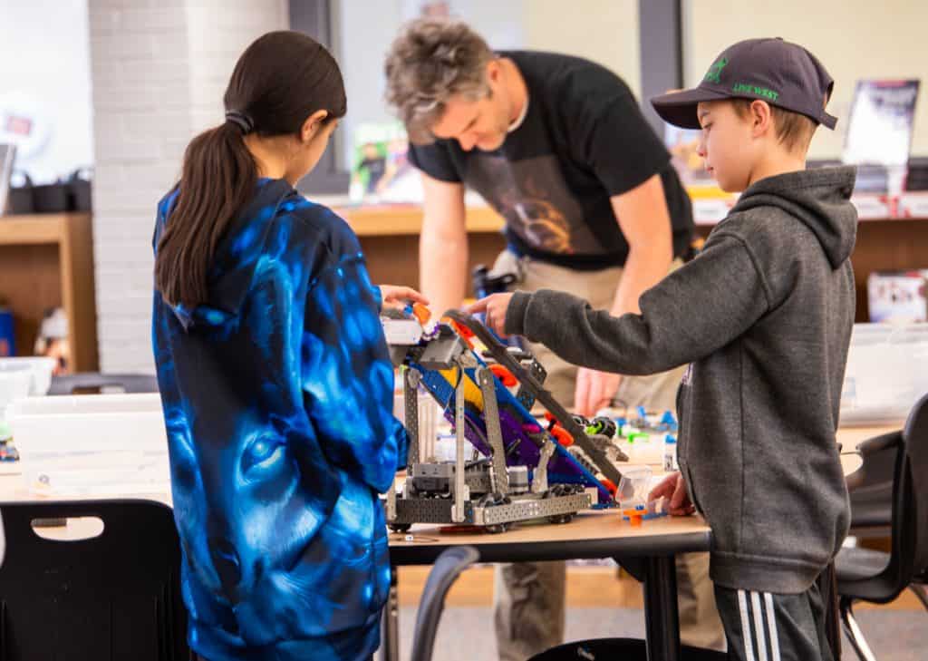 Erie Elementary students fixing robot during robotics 