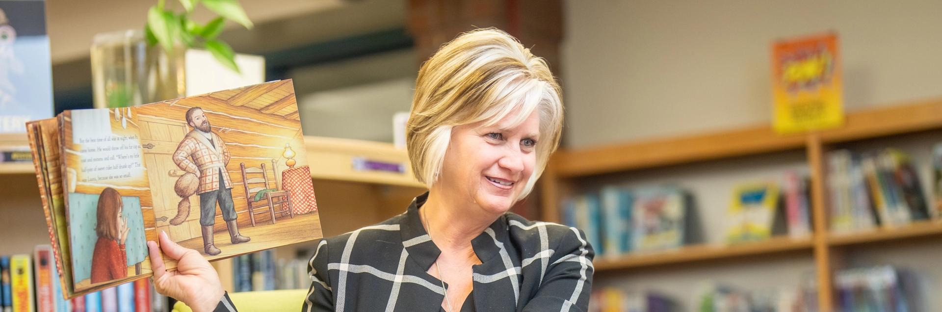 Dr. Jackie Kapushion reads to a group of St. Vrain Valley students.