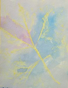 Watercolor painting of delicate leaves in soft pink, blue, and yellow hues against a light background.
