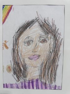 A child's colorful drawing of a girl with brown hair, wearing a purple top, smiling against a white background.