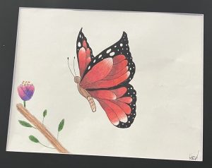 A colorful butterfly with red and black wings rests near a purple flower on a branch. The artwork is framed.