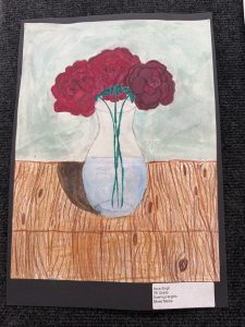 A colorful drawing of red roses in a vase on a wooden table, with a light green background.