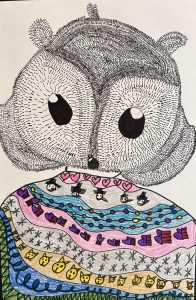 A whimsical drawing of a large-eyed animal with a patterned blanket featuring colorful designs and playful motifs.