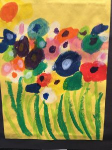 Colorful flower painting with various blooms in vibrant shades against a bright yellow background. Green stems visible.