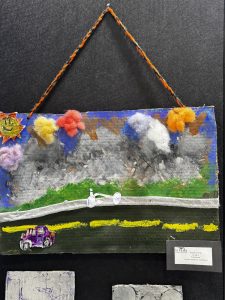 Colorful artwork depicting a road scene with a purple car, a bicycle, and a bright sky with clouds and a sun.