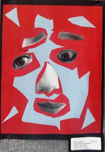 Cubist self-portrait featuring layered cutouts in red and blue, showcasing eyes, nose, and mouth.