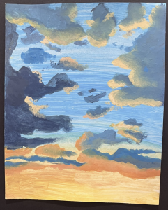 A vibrant sky painted with clouds in shades of blue, orange, and yellow, depicting a sunset atmosphere.