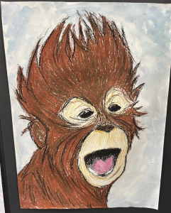 A colorful drawing of a smiling monkey with spiky brown fur and large, expressive eyes against a light blue background.