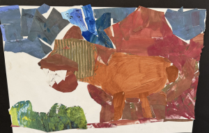 A colorful collage depicting a brown animal with sharp teeth, surrounded by abstract shapes in various colors.