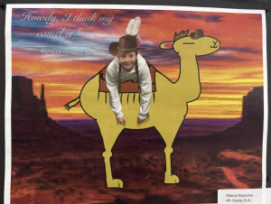 A child in a cowboy hat and bunny ears sits on a cartoon camel against a colorful sunset background.