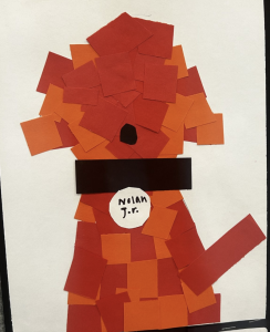 Collage of a character made with red and orange paper squares, featuring a black band and labeled "Nolan Jr."