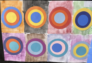 Colorful paper circles arranged in a grid, each with varying colors and backgrounds, showcasing art creativity.
