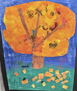 A colorful child's artwork of a tree with orange leaves, a brown trunk, and green grass with scattered orange shapes.