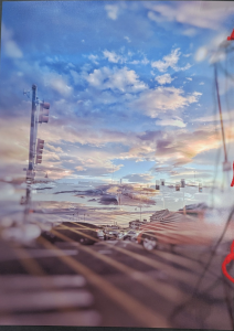 A vibrant sunset sky reflects over a busy street with traffic lights and cars visible below.