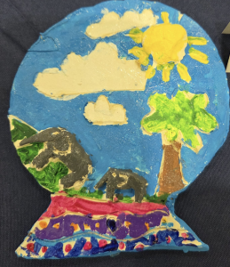 A colorful painted scene featuring two elephants, a tree, clouds, and a sun against a blue background.