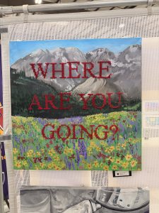 A colorful painting features mountains and a flower-filled field with the text "WHERE ARE YOU GOING?" prominently displayed.