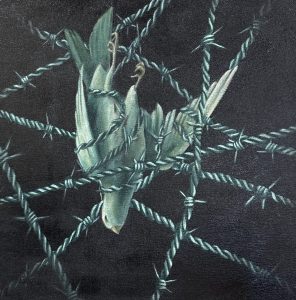 A bird is entangled in barbed wire against a dark background, symbolizing confinement and struggle.