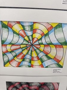 Colorful spiral artwork featuring red, green, yellow, and blue curved lines creating a 3D illusion.