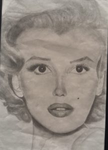 Pencil drawing of a woman with wavy hair, large eyes, and full lips, showcasing a classic portrait style.
