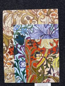 Colorful artwork featuring various floral patterns and textures in a patchwork design.