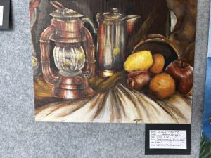 A still life painting featuring a lantern, a silver pot, and various fruits on a table.