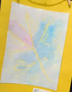 A watercolor painting featuring soft blue and pink hues with yellow leaf outlines on a yellow background.